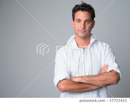 Portrait of handsome Hispanic man with arms crossed 57725423