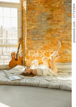 Beautiful young woman relaxing at home, comfort and calm Beautiful young woman relaxing at home, comfort and calm 57725804