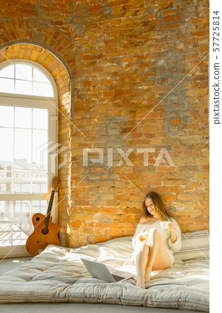 Beautiful young woman relaxing at home, comfort and calm Beautiful young woman relaxing at home, comfort and calm 57725814