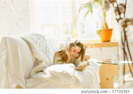 Beautiful young woman relaxing at home, comfort and calm Beautiful young woman relaxing at home, comfort and calm 57726365
