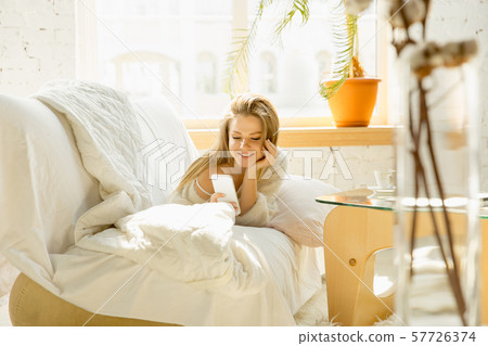 Beautiful young woman relaxing at home, comfort and calm Beautiful young woman relaxing at home, comfort and calm 57726374