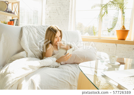 Beautiful young woman relaxing at home, comfort and calm Beautiful young woman relaxing at home, comfort and calm 57726389