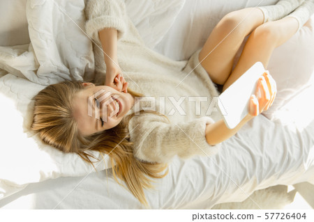 Beautiful young woman relaxing at home, comfort and calm 57726404