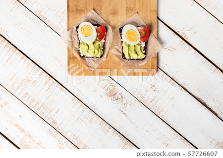 Diet food. Two egg-and-tomato avocado sandwiches. 57726607