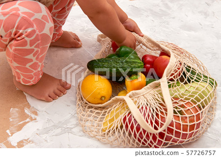 Eco friendly mesh bag with fruit and veggies. Top view. No plastic Eco friendly mesh bag with fruit and veggies. Top view. No plastic 57726757