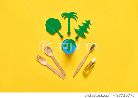 Less waste eco freindly flat lay. Green trees, Earth, wooden cutlery and toothbrush. no plastic Less waste eco freindly flat lay. Green trees, Earth, wooden cutlery and toothbrush. no plastic 57726775