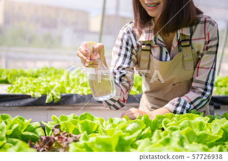 Closeup of foggy water spray bottle in female Closeup of foggy water spray bottle in female 57726938