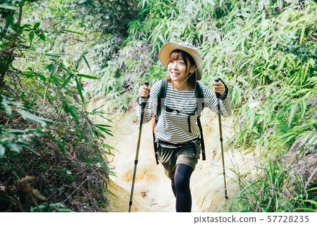 A young woman climbing 57728235