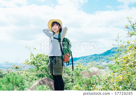 A young woman climbing 57728285