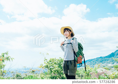 A young woman climbing 57728286