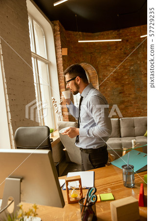 A young businessman working in office after promotion 57729235