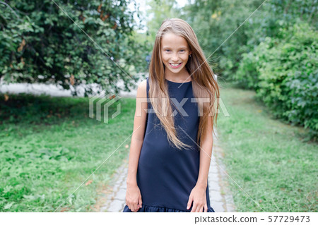 Happy school girl posing in school ourdoors Happy school girl posing in school ourdoors 57729473