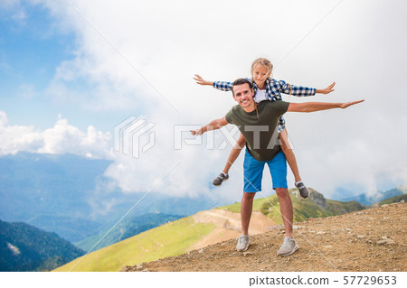 Beautiful happy family in mountains in the background of fog 57729653