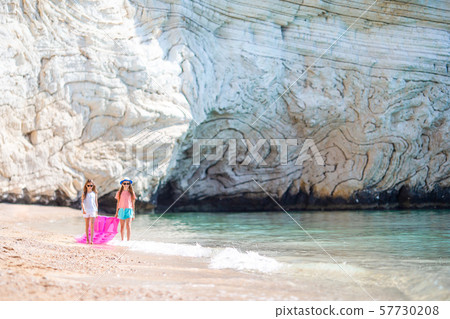 Little girls having fun at tropical beach during summer vacation playing together 57730208