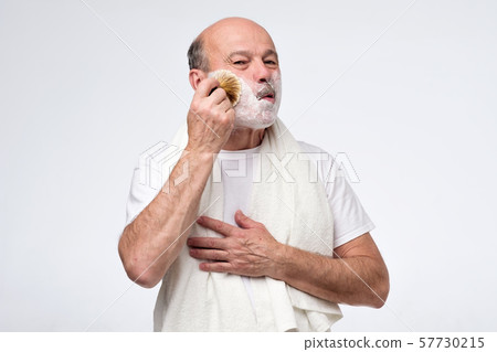 Mature hispanic man put shaving foam on beard and mustache. Mature hispanic man put shaving foam on beard and mustache. 57730215