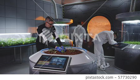 Scientist planting seedlings on Martian base Scientist planting seedlings on Martian base 57730290