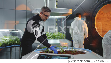 Scientist planting seedlings on Martian base 57730292
