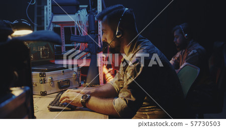 Soldier following car movement on computer Soldier following car movement on computer 57730503