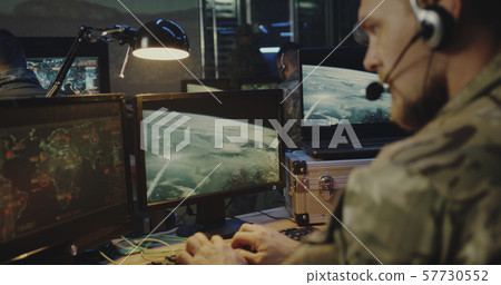 Soldiers controlling rocket launch on computer Soldiers controlling rocket launch on computer 57730552