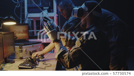 Soldier using VR headset and gloves 57730574