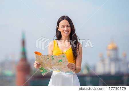 Happy young urban woman in european city. 57730579