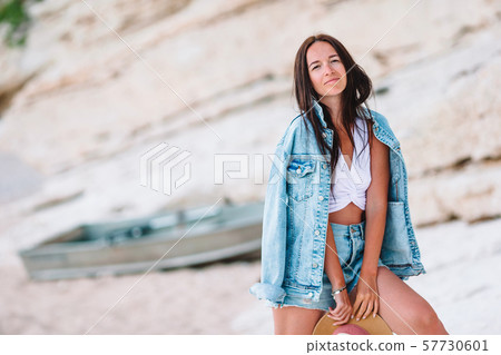 Woman laying on the beach enjoying summer holidays looking at the sea 57730601