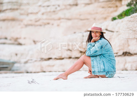 Woman laying on the beach enjoying summer holidays looking at the sea 57730629