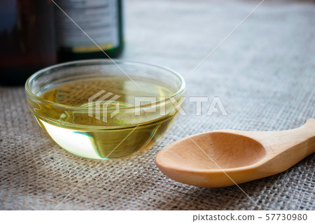 Liquid coconut MCT oil in round glass bowl with 57730980