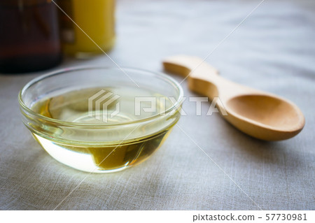 Liquid coconut MCT oil in round glass bowl with 57730981