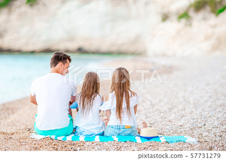 Father and two daughters on the beach 57731279