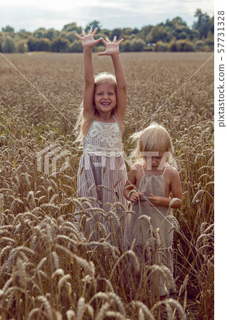 Woman with arms outstretched in a wheat field Woman with arms outstretched in a wheat field 57731328