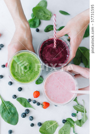 Row of healthy fresh fruit and vegetable smoothies with assorted ingredients Row of healthy fresh fruit and vegetable smoothies with assorted ingredients 57731595