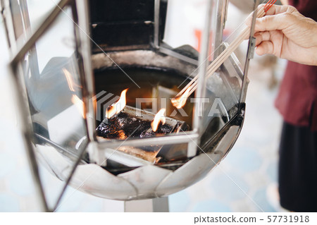 Hands of old men, light the incense sticks Hands of old men, light the incense sticks 57731918