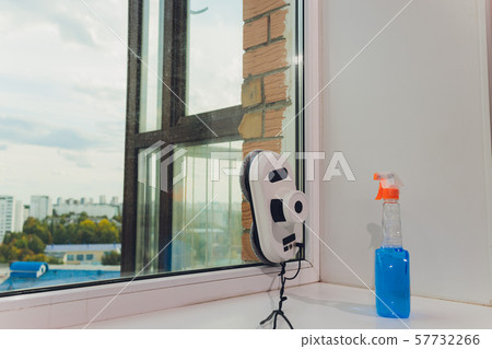 Vacuum cleaner robot cleaning window in high building outdoor. Vacuum cleaner robot cleaning window in high building outdoor. 57732266