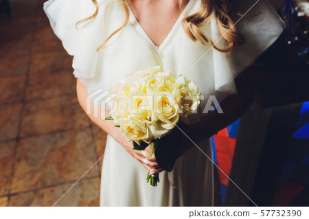 Beautiful wedding bouquet in hands of the bride. 57732390