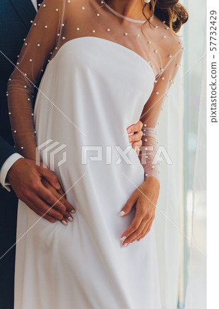 Elegant wedding couple. Bride and groom embracing at wedding day. Elegant wedding couple. Bride and groom embracing at wedding day. 57732429