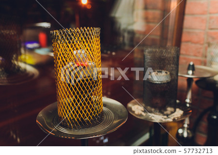 Shisha hookah with red hot coals. Sparks from breathe. Modern hookah with coconut charcoal and 57732713