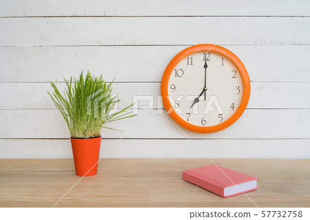Round wall clock, pink notepad on the table and Round wall clock, pink notepad on the table and 57732758