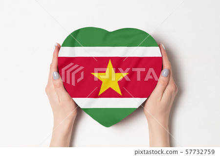 Flag of Suriname on a heart shaped box in a female Flag of Suriname on a heart shaped box in a female 57732759