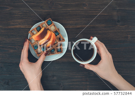 Belgian waffles with fruit and berries. Female Belgian waffles with fruit and berries. Female 57732844