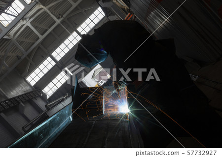 Industrial Worker at the factory welding closeup long exposure sparks 57732927