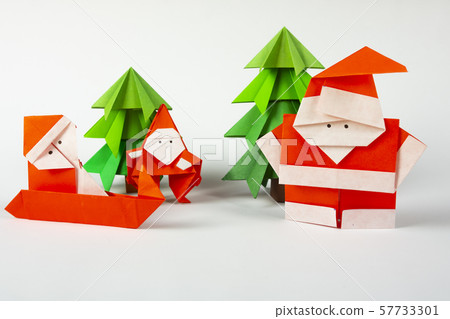 New Year card handmade origami Santa Claus on a sleigh with trees. Christmas concept winter crafted New Year card handmade origami Santa Claus on a sleigh with trees. Christmas concept winter crafted 57733301