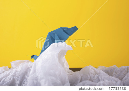 whale on a wave handmade origami craft paper art on a yellow paper background whale on a wave handmade origami craft paper art on a yellow paper background 57733388