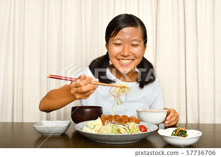 Girl eating tonkatsu Girl eating tonkatsu 57736706
