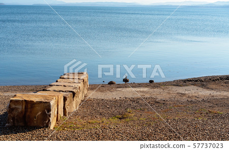 Remains Of Old Rock Jetty On A Lake 57737023