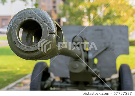 a sample of a military cannon close-up on the background of a residential area a sample of a military cannon close-up on the background of a residential area 57737557