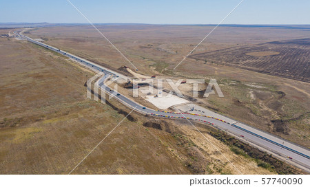 Aerial road constructions, machinery and mine equipment near road on sandy surface Aerial road constructions, machinery and mine equipment near road on sandy surface 57740090