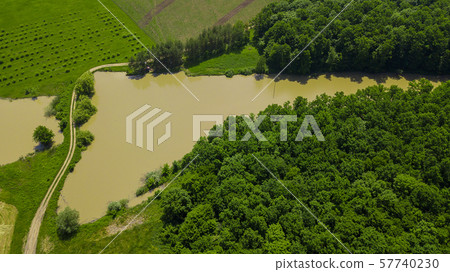 Aerial landscape nature - Dense green forest, green meadows, lake in southern Russia Aerial landscape nature - Dense green forest, green meadows, lake in southern Russia 57740230