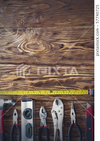 Close up tools on a wooden background. Close up tools on a wooden background. 57740725