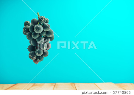 Beautiful wine violet grapes on a red wooden table Beautiful wine violet grapes on a red wooden table 57740865